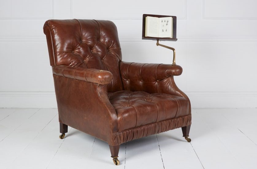 Edwardian tufted library chair covered in hand antiqued Italian hide with brass mounted reading slope